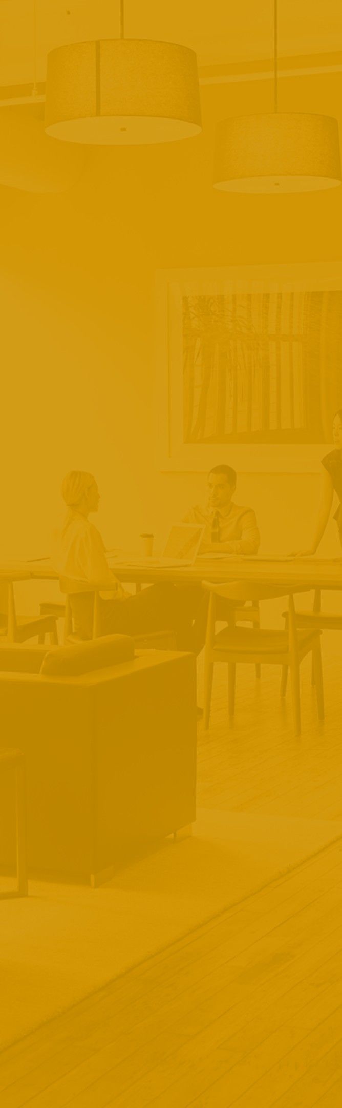 A busy office with people working at their desks and moving around the office